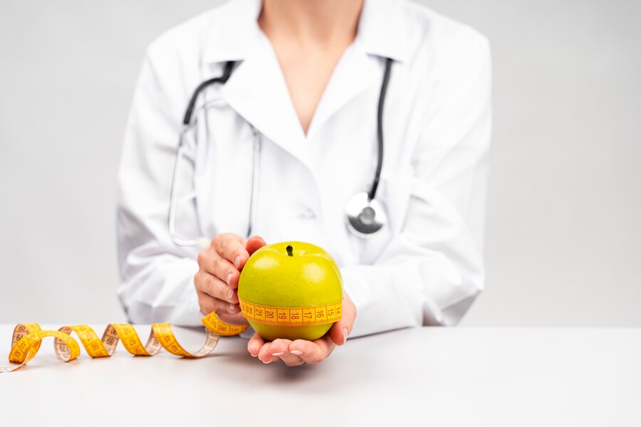 nutritionist holding an apple